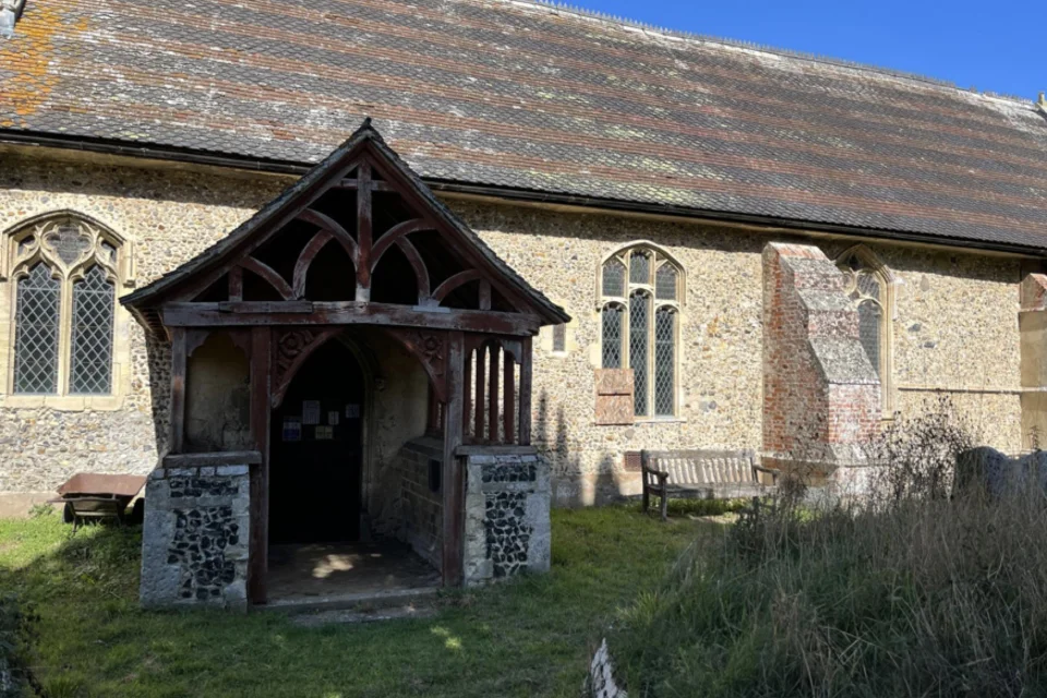 A tranquil setting for a stone church with wooden framed porch