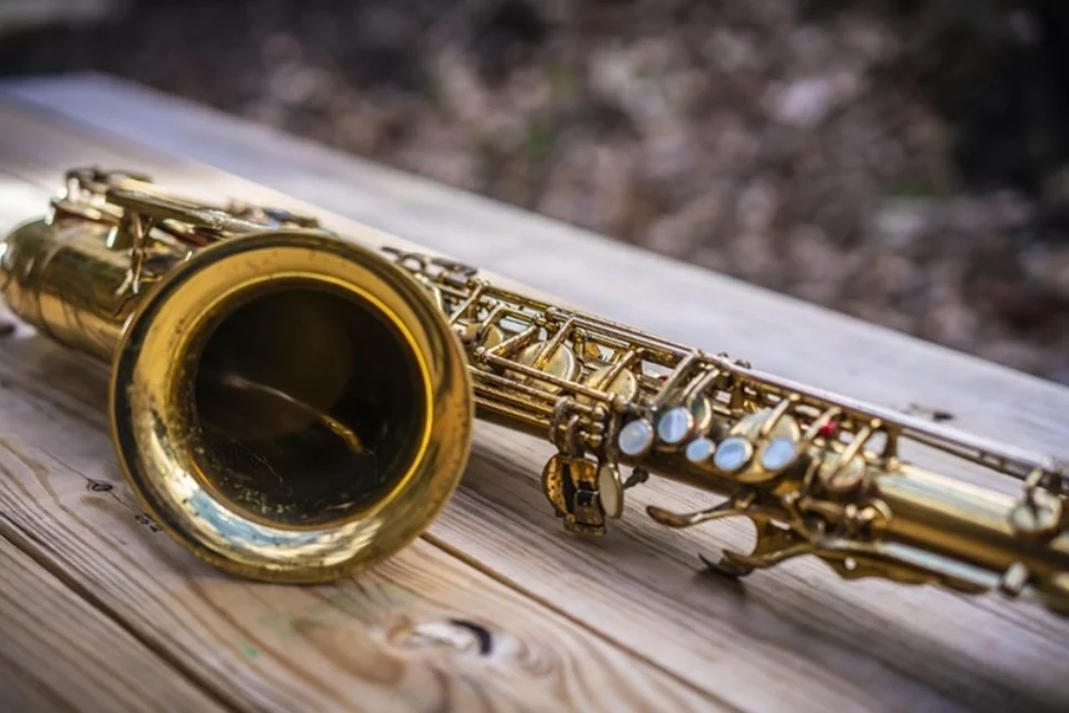 saxophone laying on a wooden table