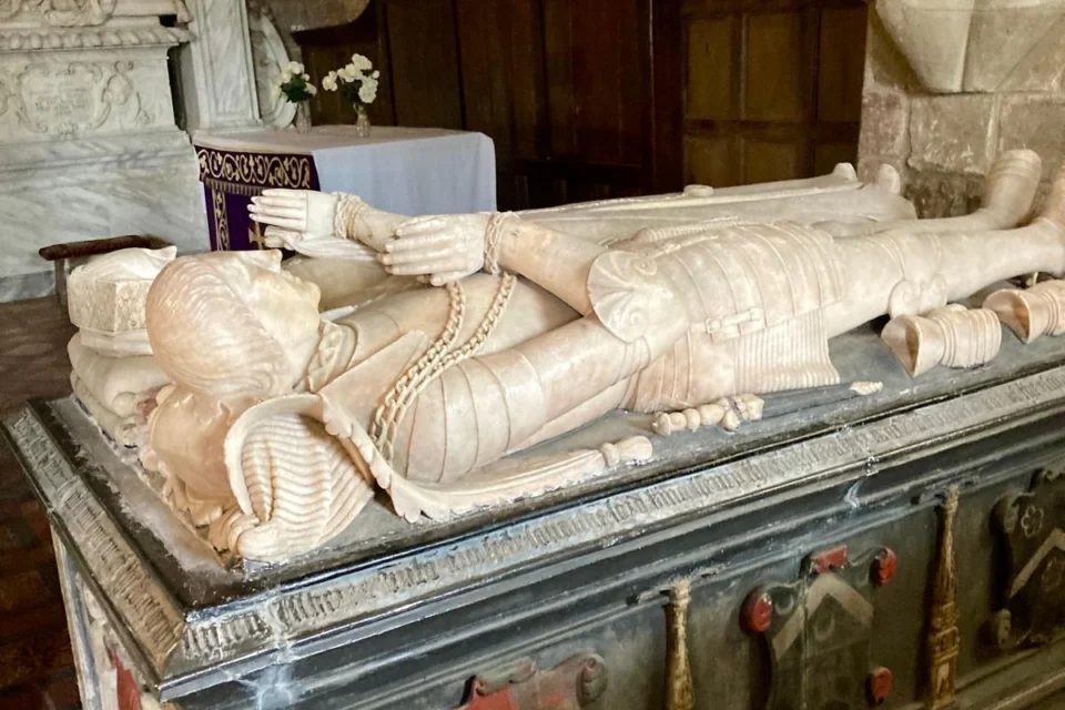 Chest tomb with statues of reclining knight and lady, inside church