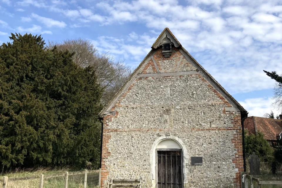 Exterior of the church built with flinted walls and red brick