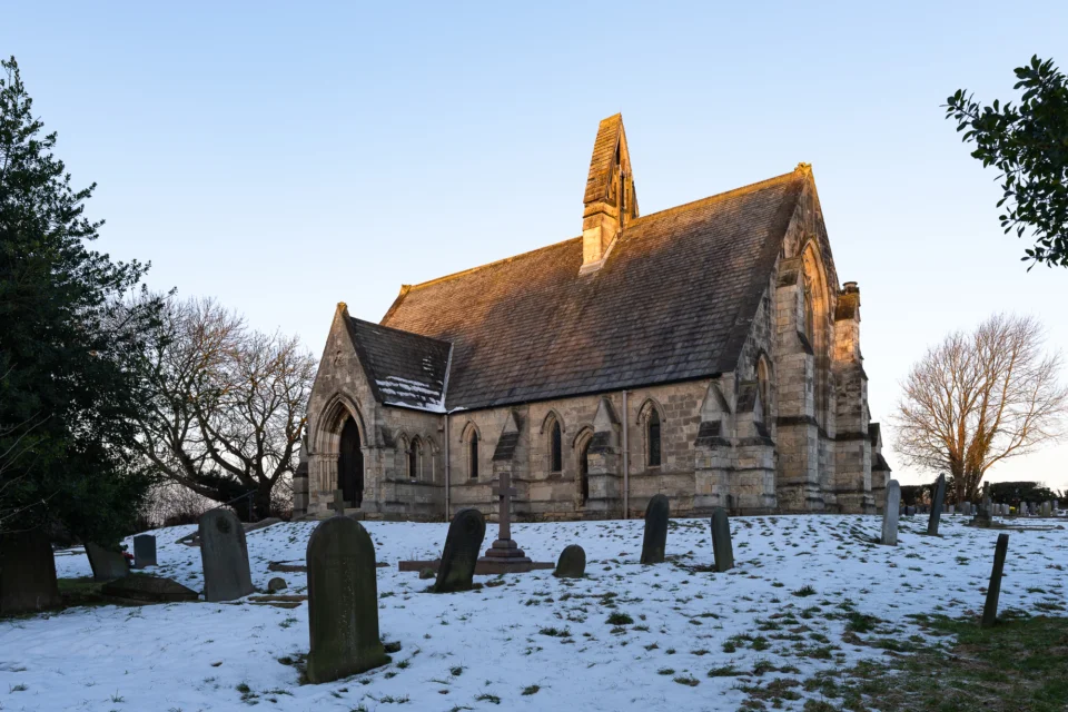 Exterior of St John's church, Cadeby in the snow