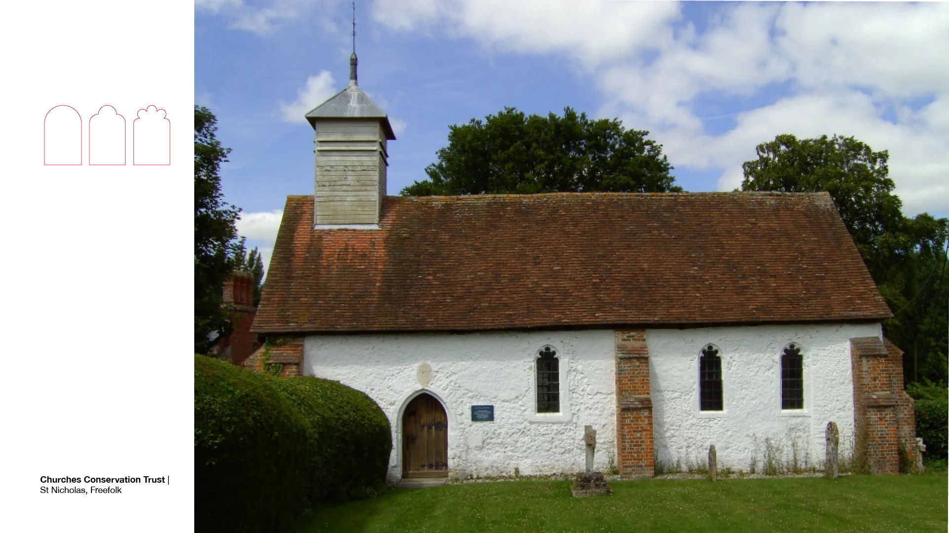 Exterior of small whitewashed church with arch windows, red brick pillars, red tile roof and small grey brick tower